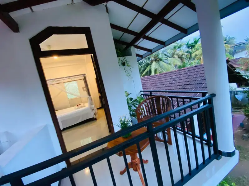 First-floor balcony with a view of the trees and neighbouring rooftops