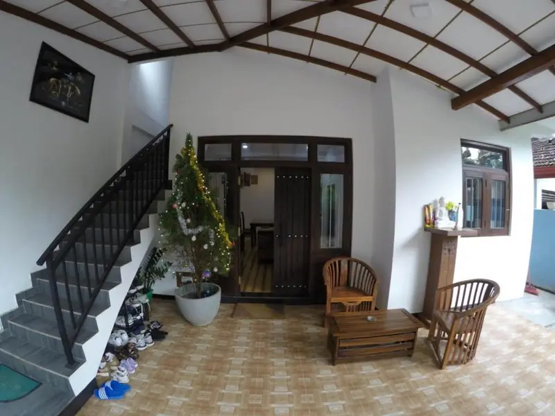 Ground-floor hall with staircase and timber armchairs